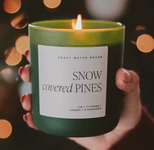Snow covered pines candle