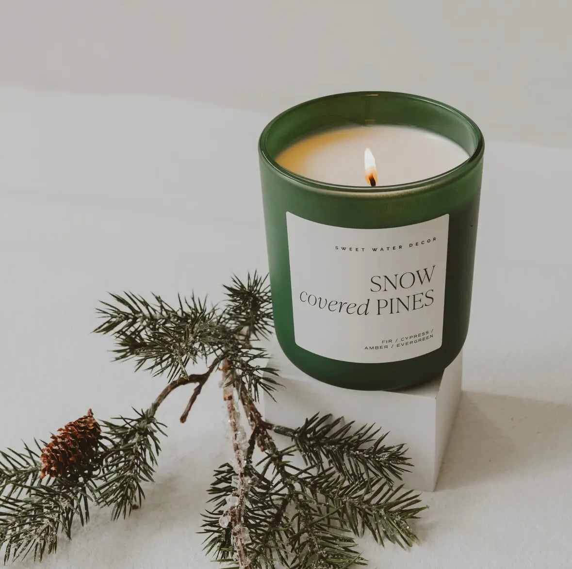 Snow covered pines candle